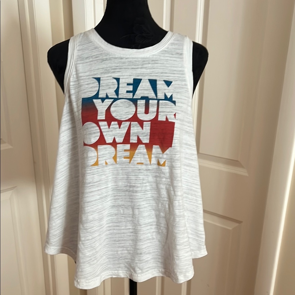 Woman’s, white, muscle, tee. Logo on front “Dream Your Own Dream”.